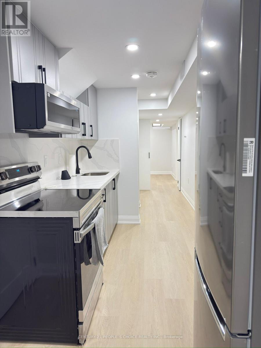 A modern kitchen with a refrigerator on the right.