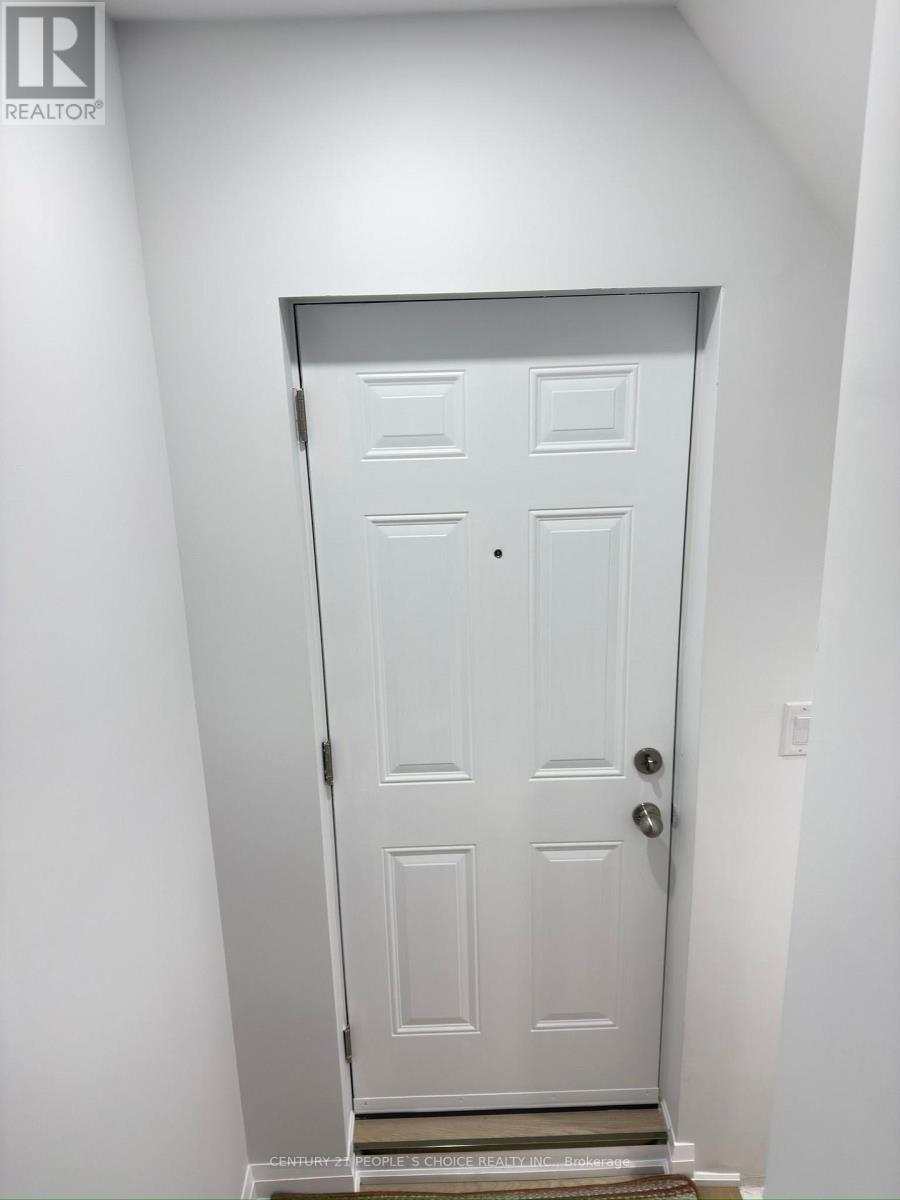 A white door with a handle and a doorknob.