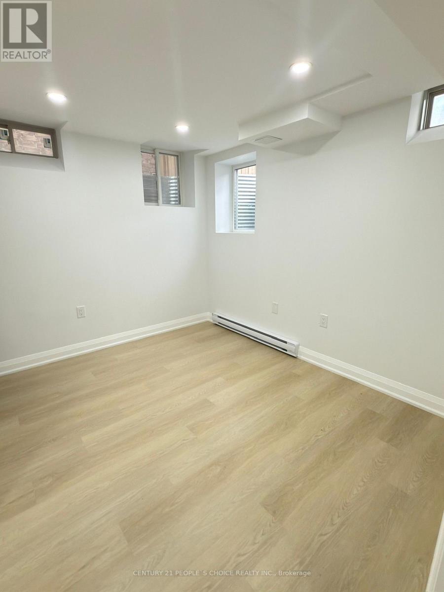 A room with light wood flooring and white walls.