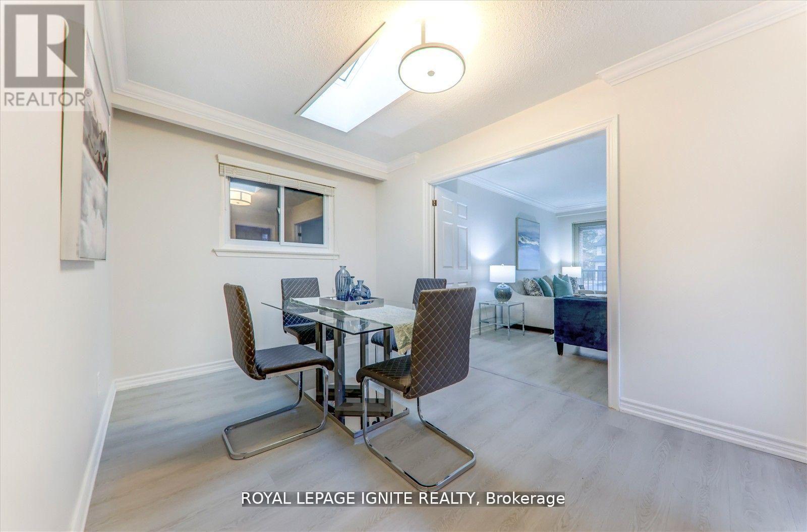 A dining room with a glass table and chairs.