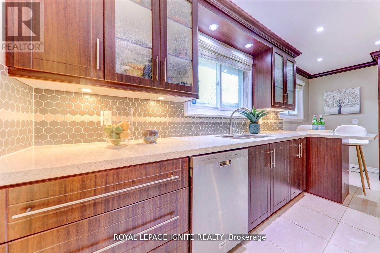 A kitchen with wooden cabinets and a white dishwasher.