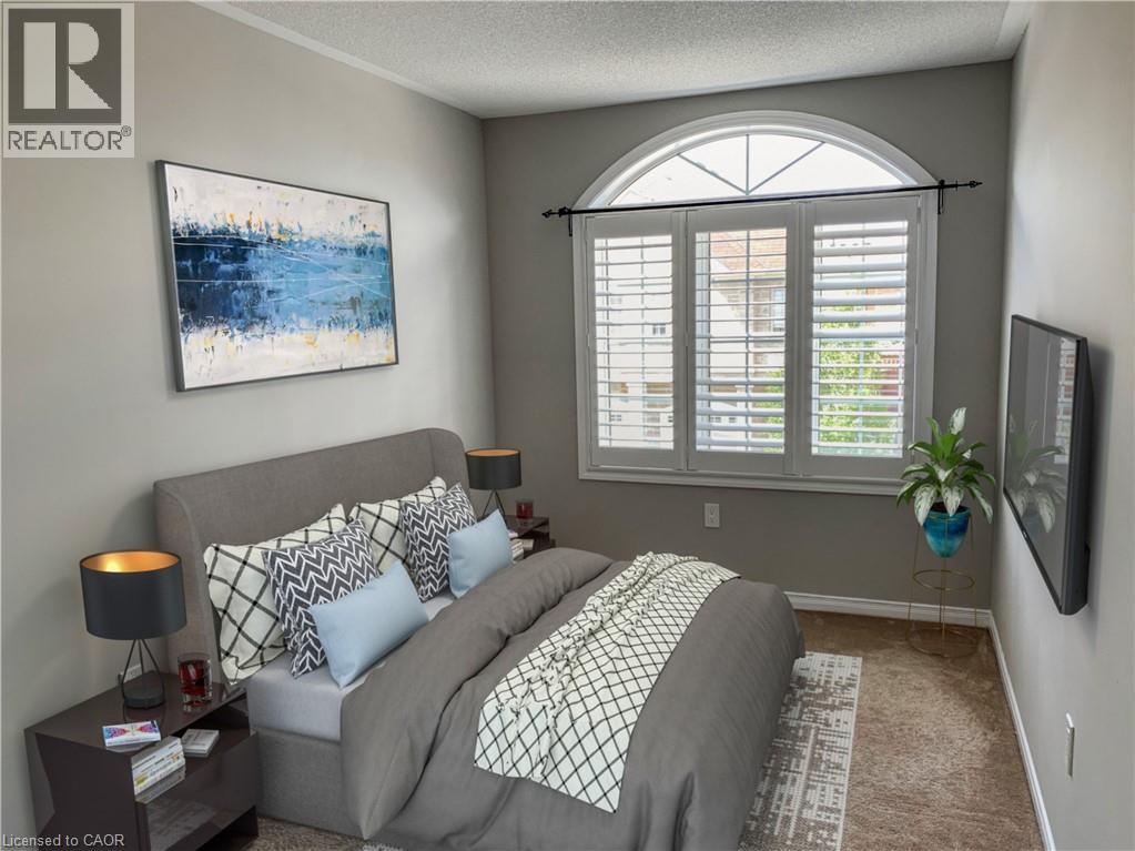 A bedroom with a large bed and a painting on the wall.