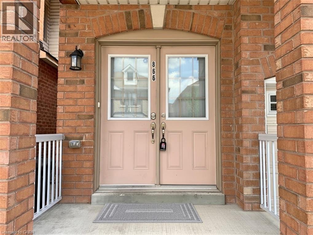 A pink door with a glass window and a black handle.