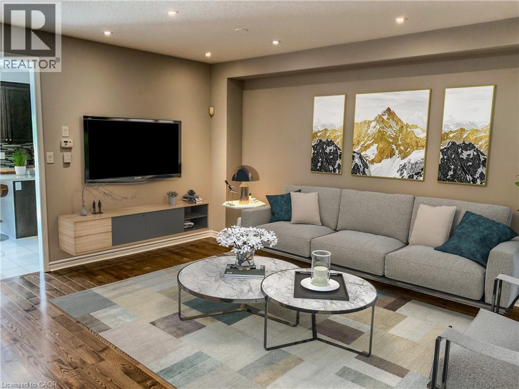 A living room with a grey couch, a coffee table, and a television.