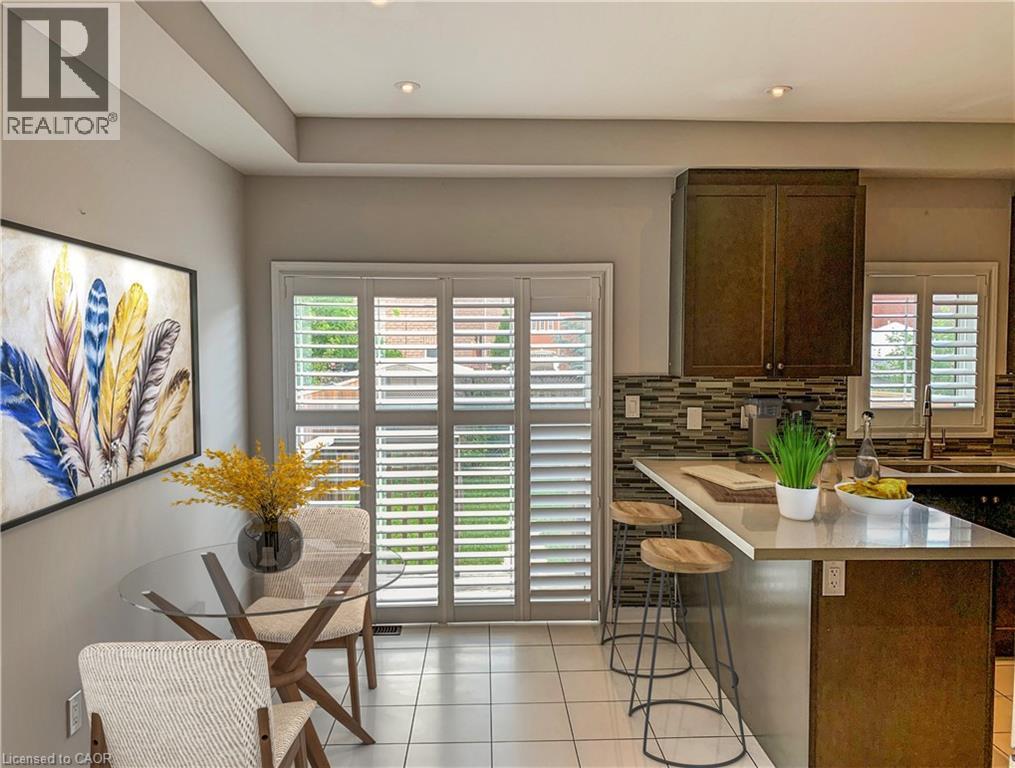A kitchen with a dining table and chairs.