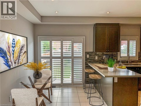 A kitchen with a dining table and chairs.
