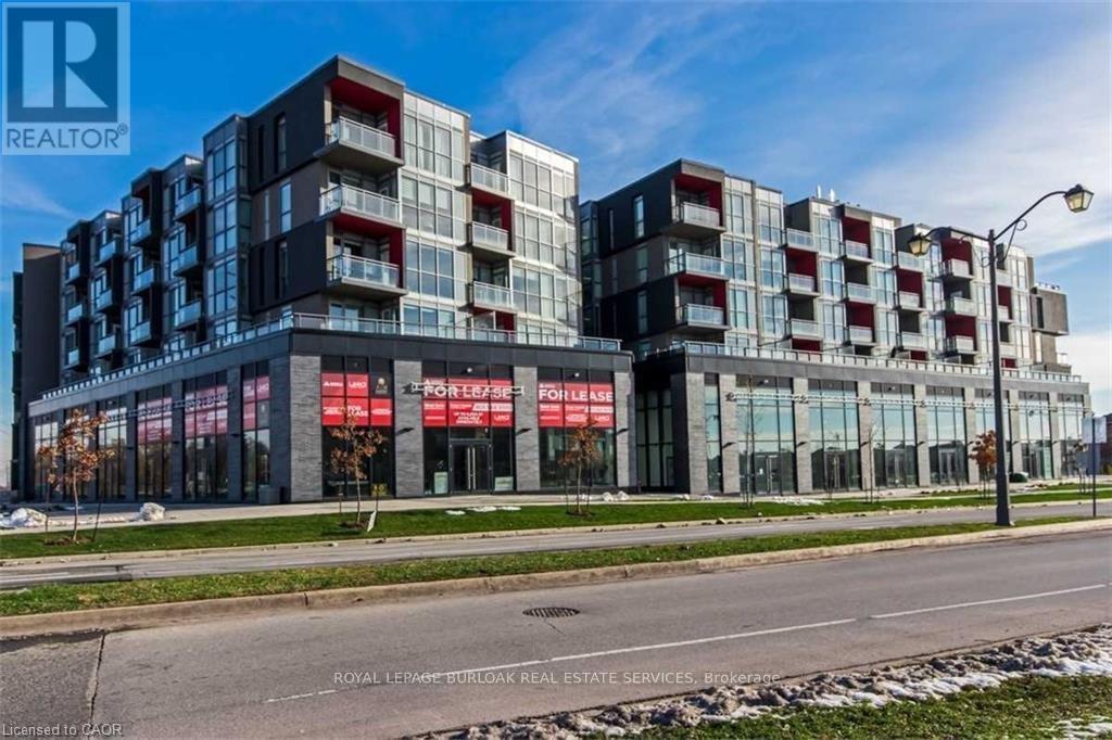 A modern multi-story building with a glass facade and a red and white sign that reads "REALTOR".