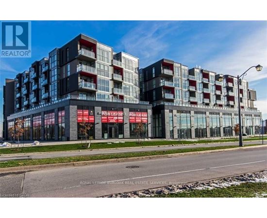 A modern multi-story building with a glass facade and a red and white sign that reads "REALTOR".