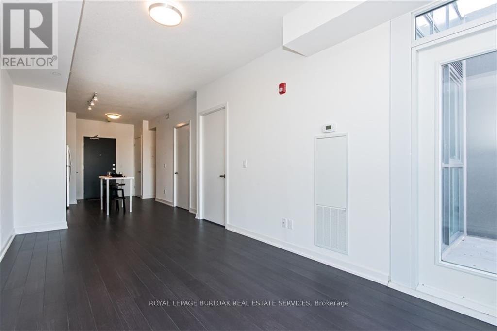 A long hallway with a table and chairs in the middle.