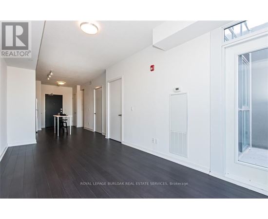 A long hallway with a table and chairs in the middle.