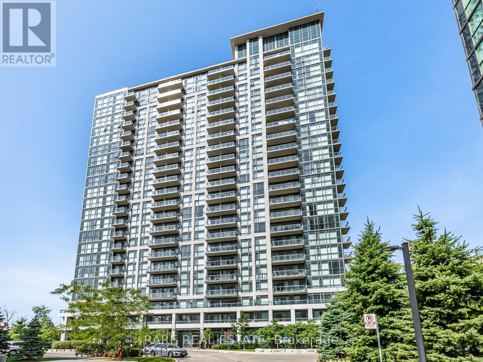 A tall residential building with a clear blue sky in the background.