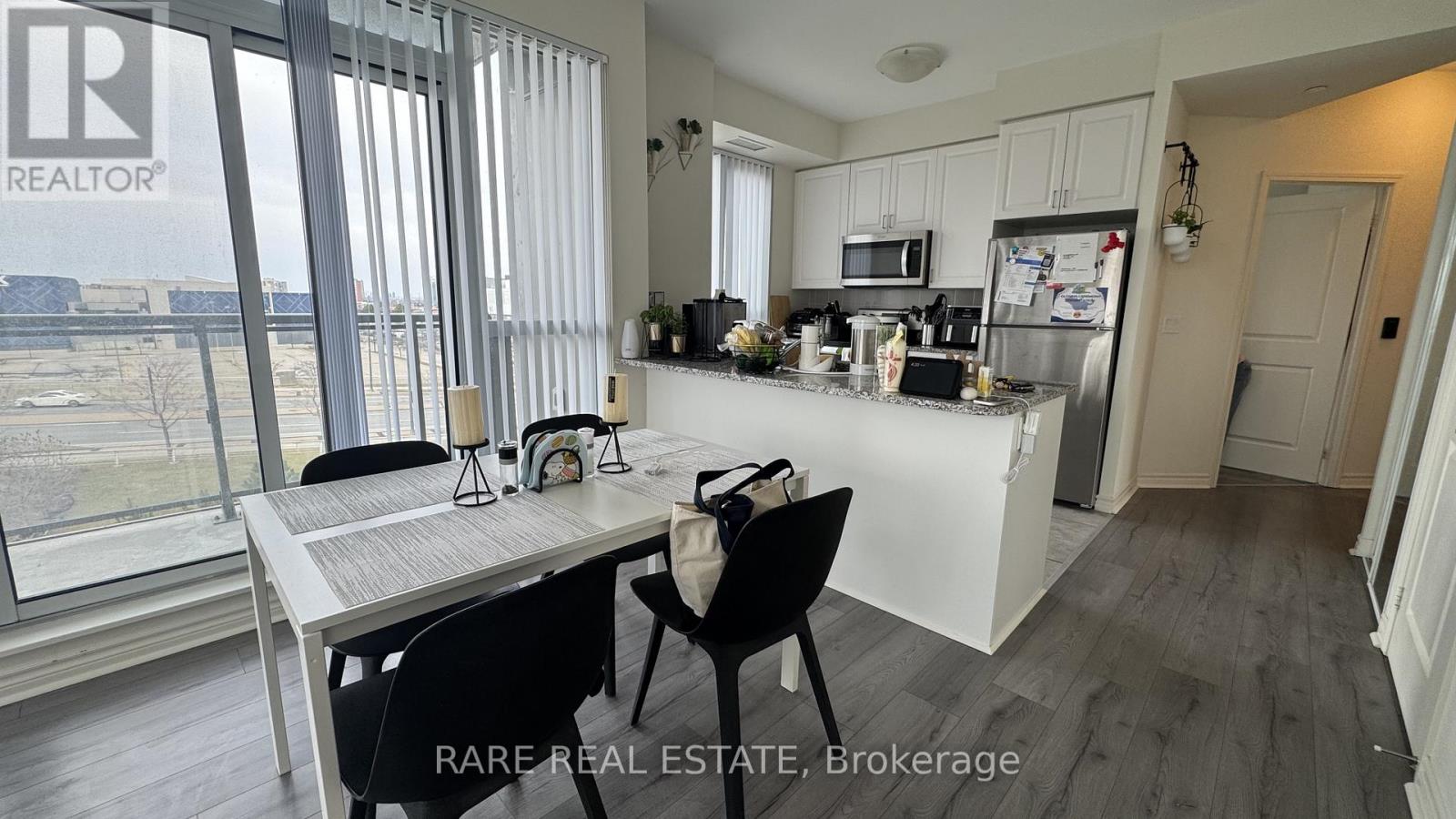 A modern kitchen with a dining table and chairs.