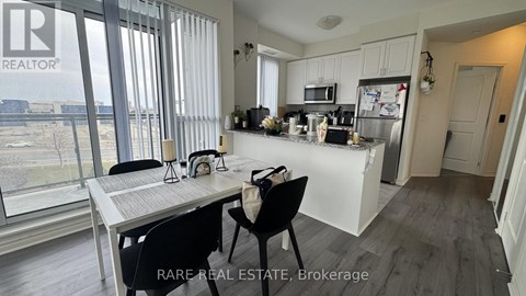 A modern kitchen with a dining table and chairs.