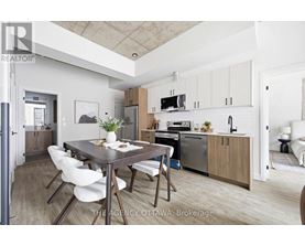 A modern kitchen with a dining table and chairs.