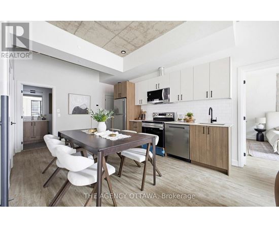 A modern kitchen with a dining table and chairs.