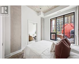 A bedroom with a large bed and a view of the city.