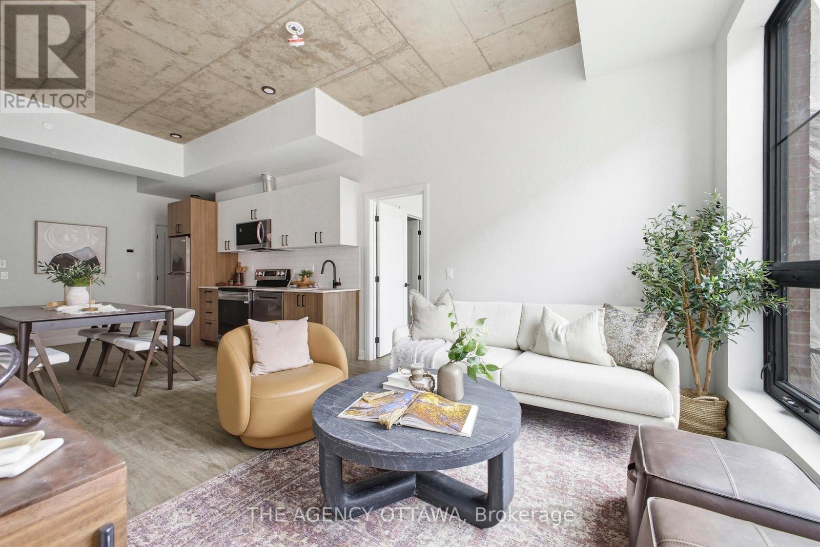 A living room with a grey coffee table and a white couch.