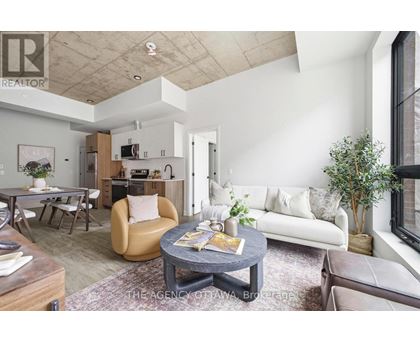 A living room with a grey coffee table and a white couch.