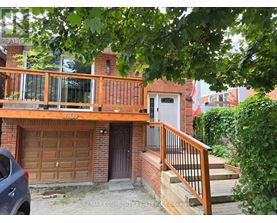 A house with a brown garage door is for sale.