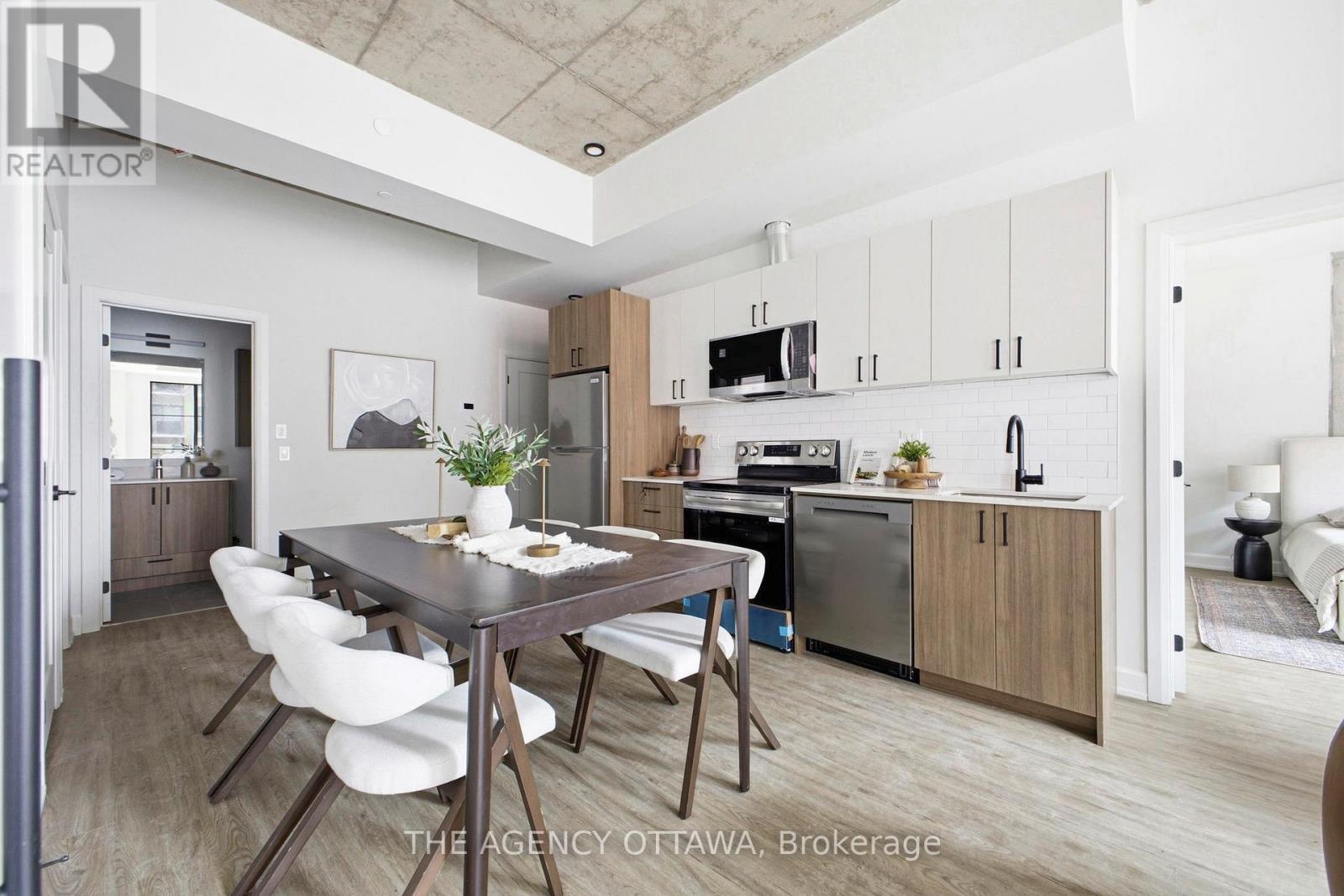 A modern kitchen with a dining table and chairs.