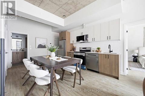 A modern kitchen with a dining table and chairs.