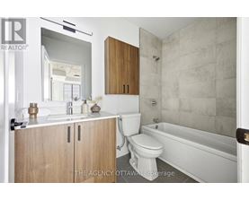 A bathroom with a toilet, sink, and bathtub.