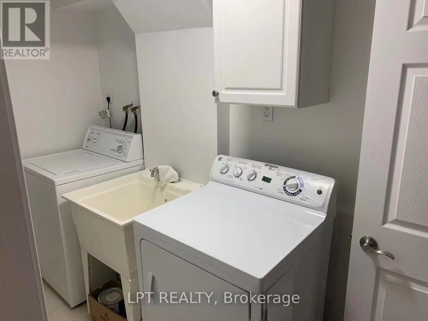 A small white laundry room with a washer and dryer.