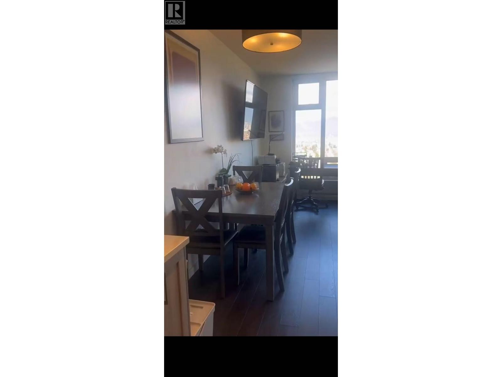 A kitchen with a table and chairs.