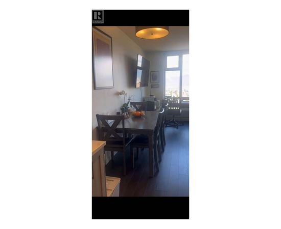 A kitchen with a table and chairs.