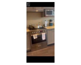 A modern kitchen with a stove and oven.