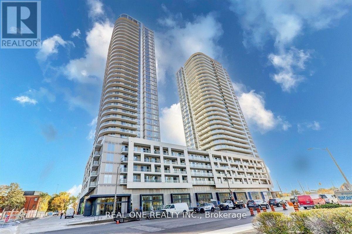 Two tall buildings with balconies are under a blue sky with clouds.