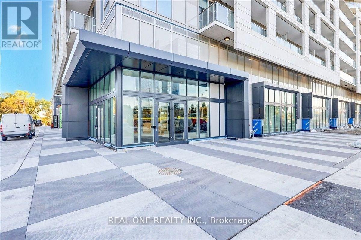 A modern building with a glass entrance and a sign that reads "REAL ONE REALTY INC., Brokerage".