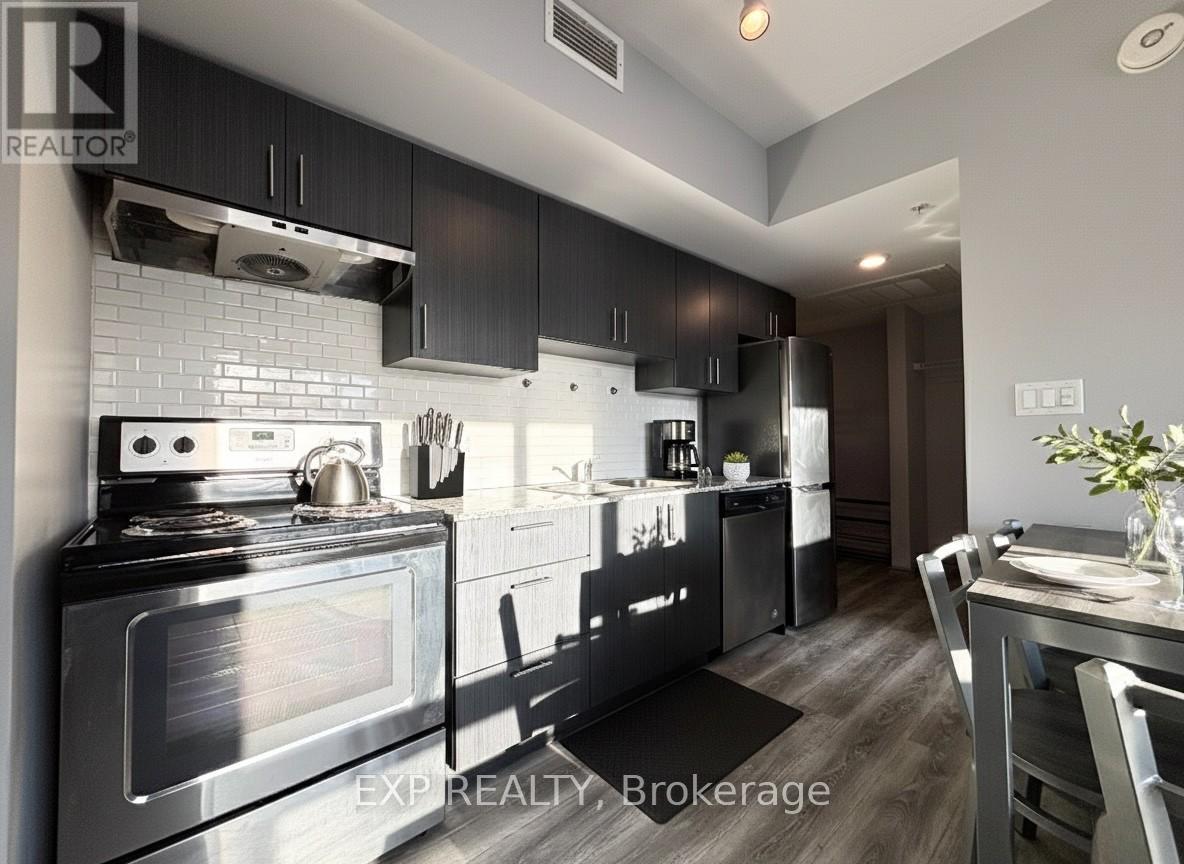 A modern kitchen with a stove top oven and a refrigerator.