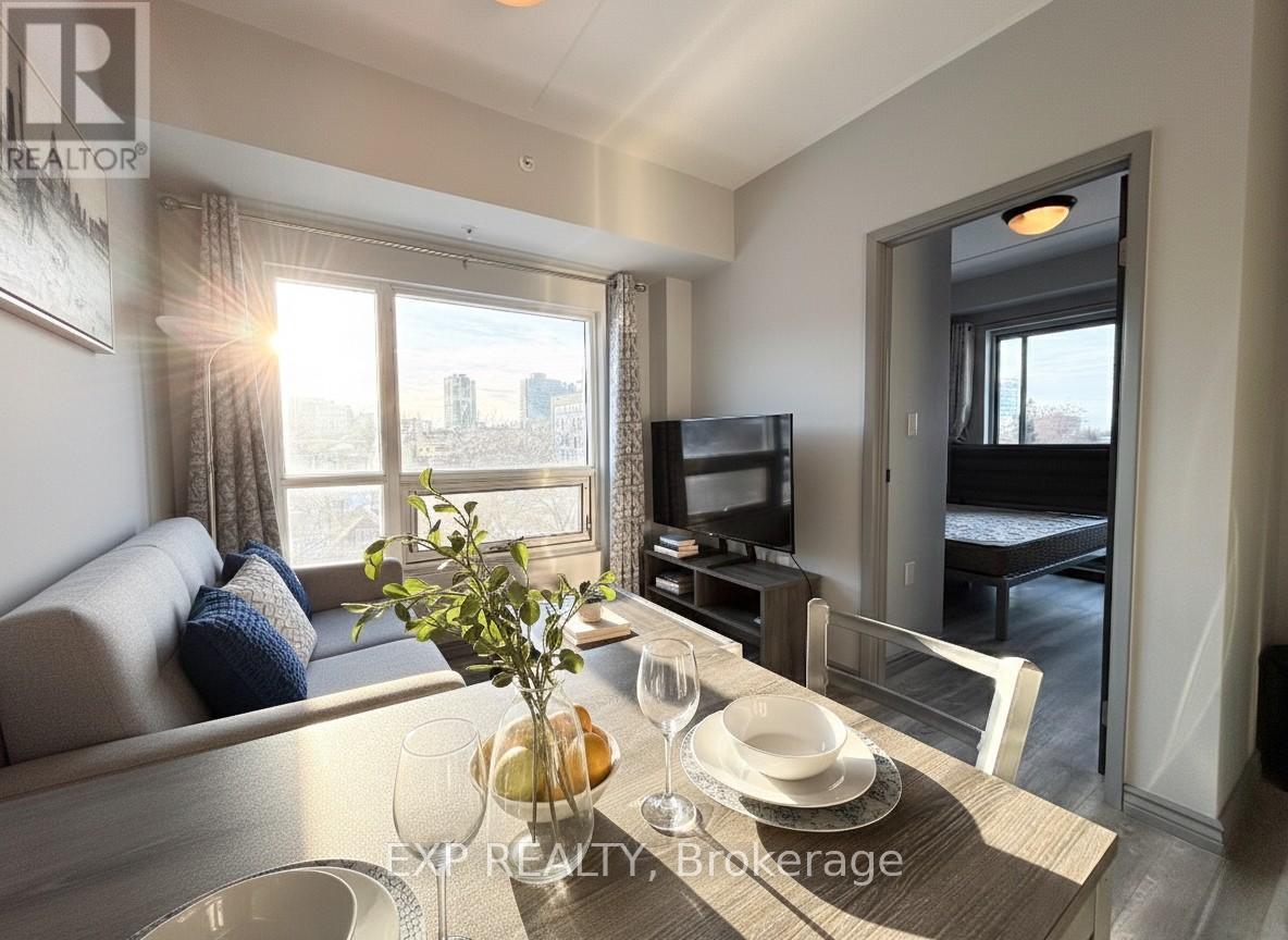 A well-lit living room with a dining table set for two.