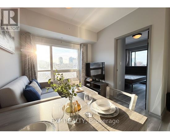 A well-lit living room with a dining table set for two.