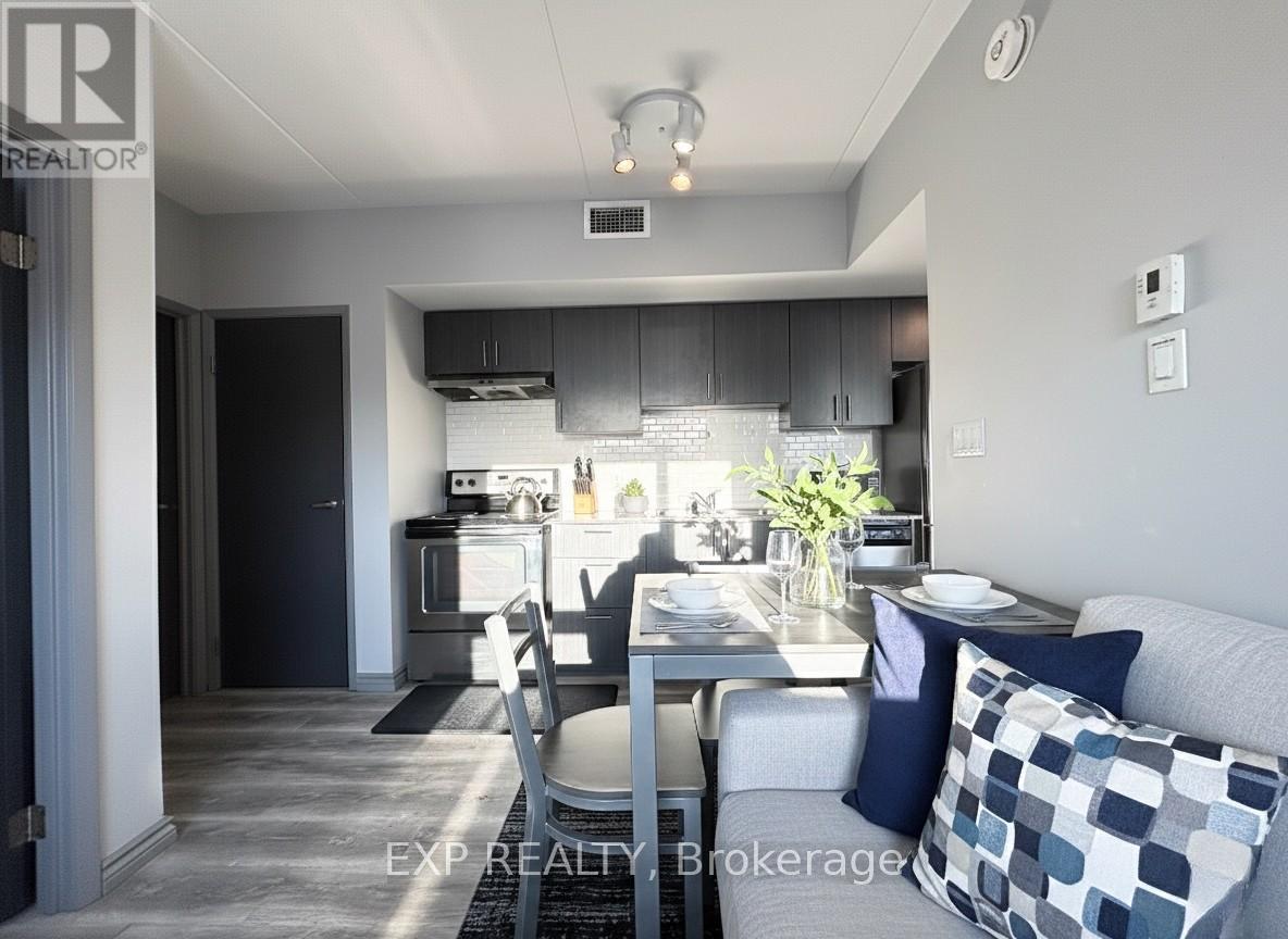 A modern kitchen with a dining table set for two.