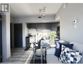 A modern kitchen with a dining table set for two.