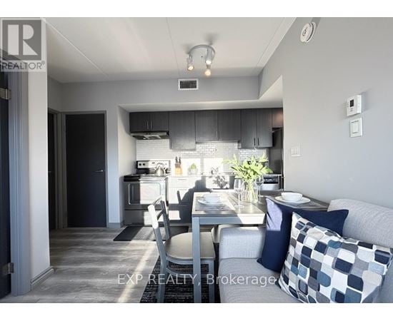 A modern kitchen with a dining table set for two.