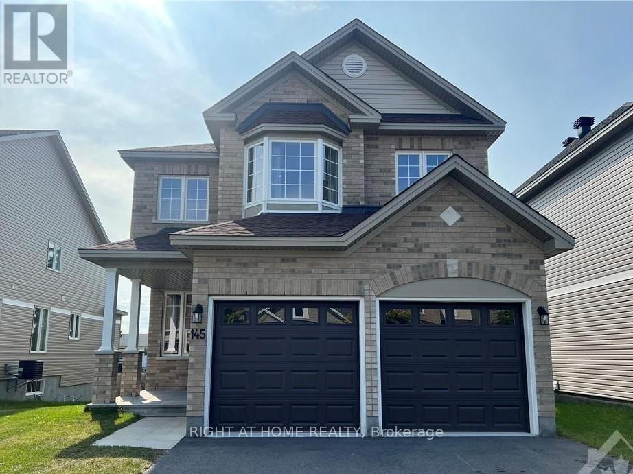 A two-story house with a garage is for sale.