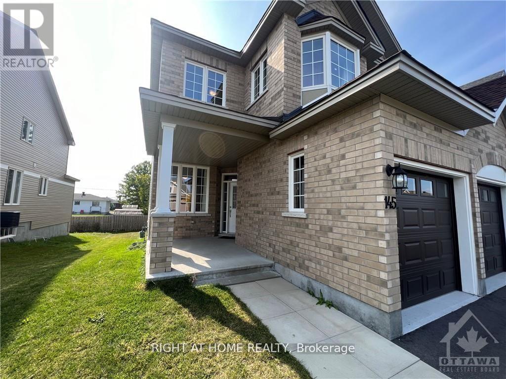 A two-story house with a garage is for sale.