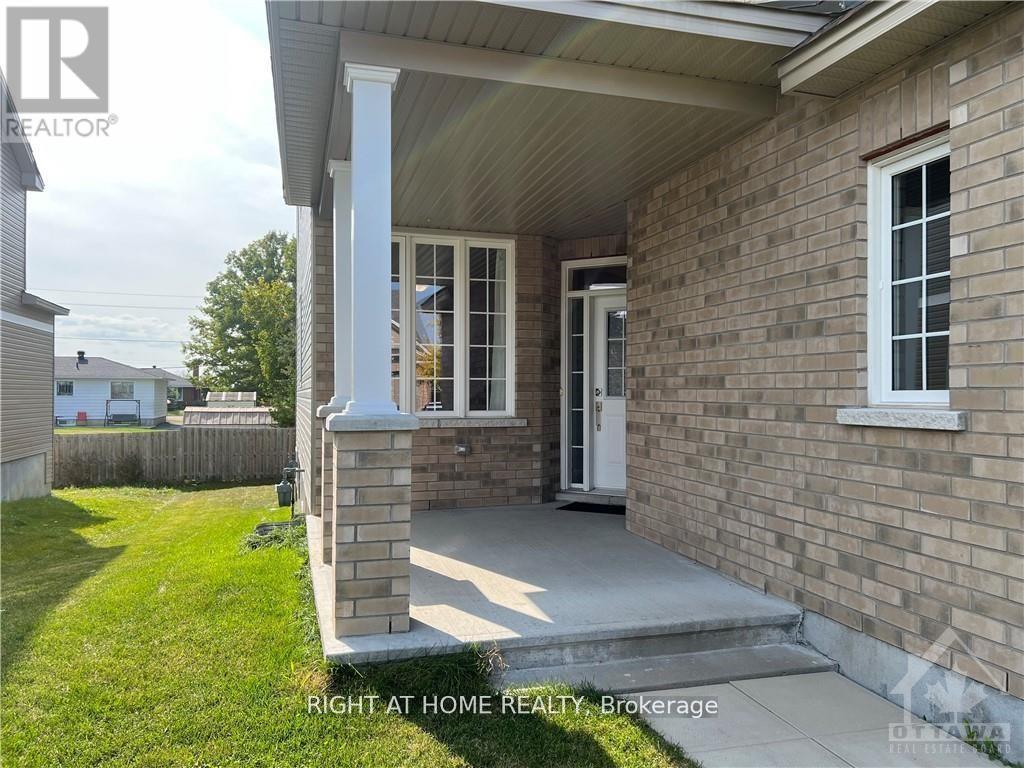 A house with a porch and a sign that says "Right at Home Realty, Brokerage".