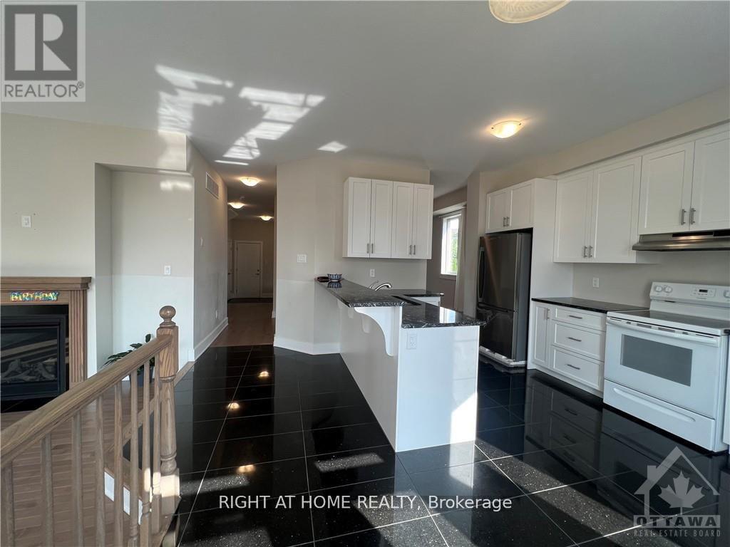 A kitchen with black countertops and white cabinets.