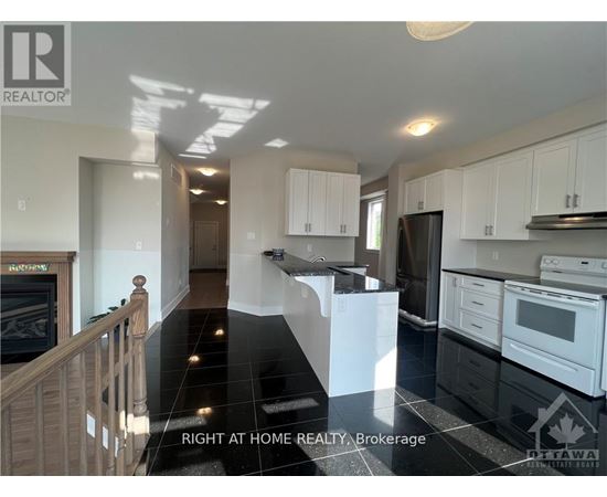 A kitchen with black countertops and white cabinets.