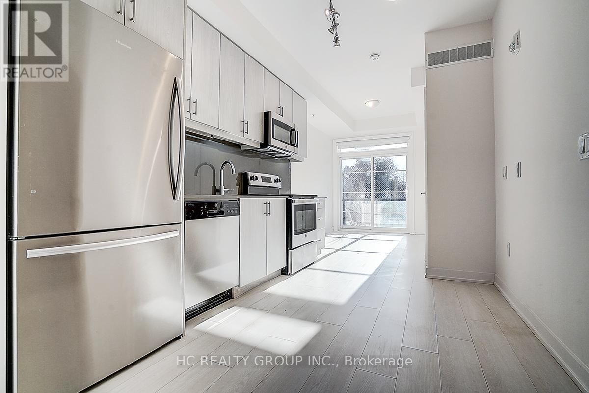 A modern kitchen with stainless steel appliances and white cabinets.