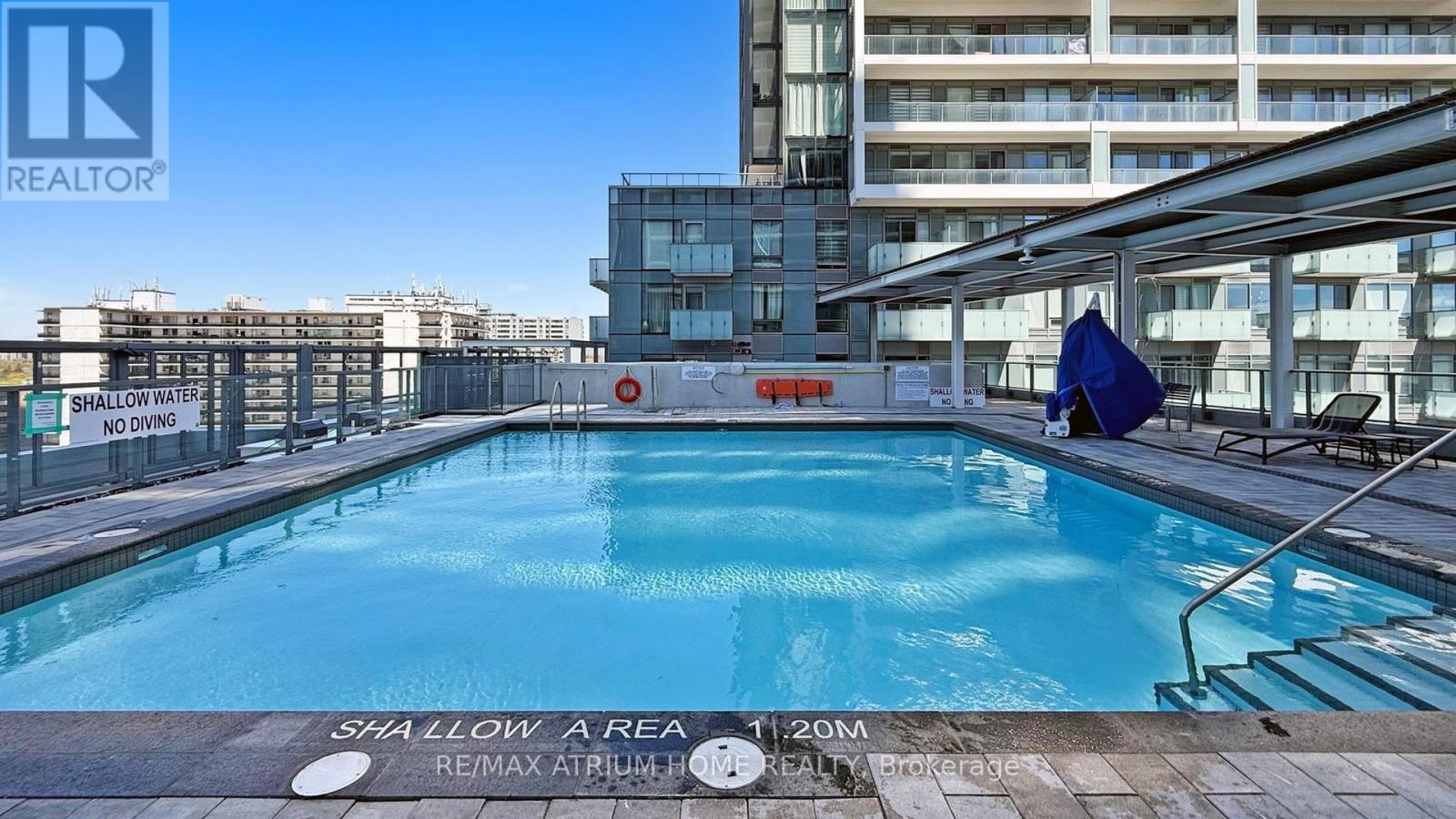 A shallow pool with a sign that says shallow area no diving.
