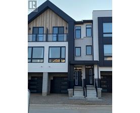 A modern two-story building with a balcony on the upper floor.