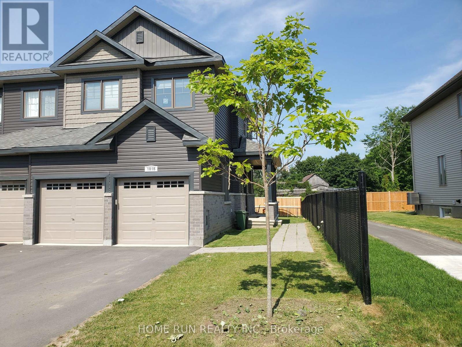 A two-story house with a garage is for sale.