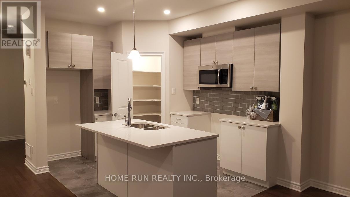 A modern kitchen with white cabinets and a central island.