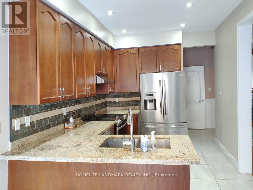 A kitchen with wooden cabinets and granite countertops.