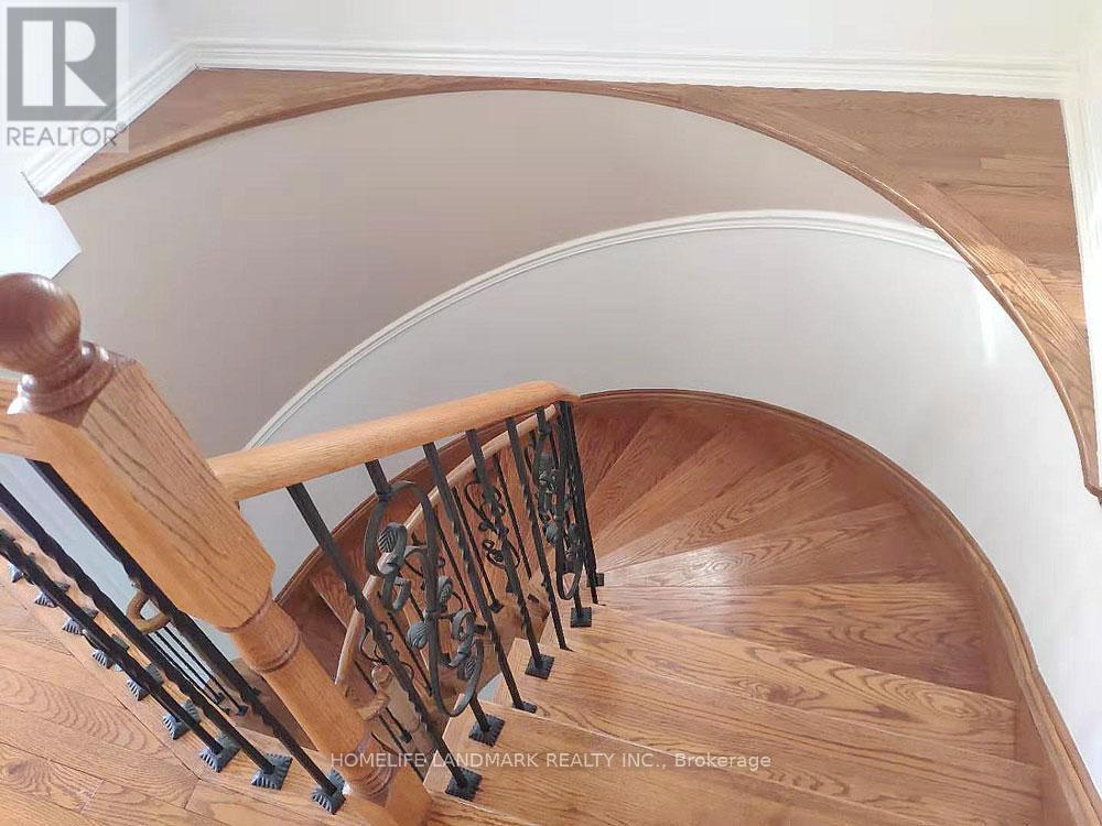 A wooden staircase with a metal railing.
